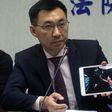 Johnny Chiang, a legislator from the Kuomintang (KMT) party, displays a video showing Taiwanese detented at a police station in Kenya, during a press conference in Taipei, in April 2016 
