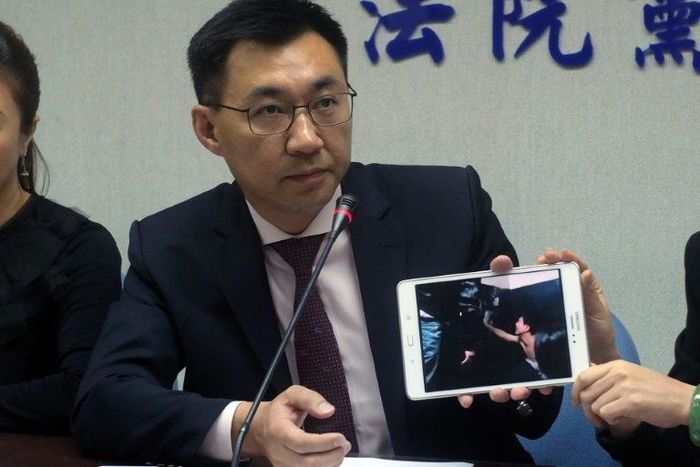 Johnny Chiang, a legislator from the Kuomintang (KMT) party, displays a video showing Taiwanese detented at a police station in Kenya, during a press conference in Taipei, in April 2016 