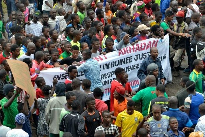Guinean opposition supporters march with banners during an anti-government protest in Conakry on August 16, 2016 