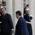 French President Francois Hollande (L) escorts Nicolas Sarkozy, former president and current head of the Les Republicains political party, before a meeting at the Elysee Palace in Paris, France, November 15, 2015.