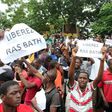 People hold signs reading "Free Rasbath", referring to radio presenter Mohamed Youssouf Bathily, during a demonstration in front of Bamako's court on August 17, 2016.