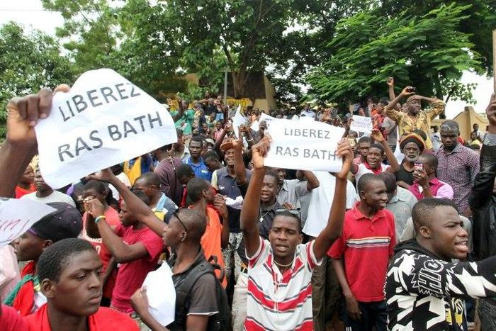 People hold signs reading "Free Rasbath", referring to radio presenter Mohamed Youssouf Bathily, during a demonstration in front of Bamako's court on August 17, 2016.