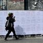 A woman walking past posters with the names of 19 women murdered by October 2018: Uruguay saw a record number of murders in 2018