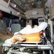 Somali policeman sits inside an ambulance as he guards an Al-Shabaab fighter injured during an exchange of gunfire after a car bomb explosion at the Banadir beach restaurant at Lido beach in Somalia's capital Mogadishu, August 25, 2016. Picture taken A...
