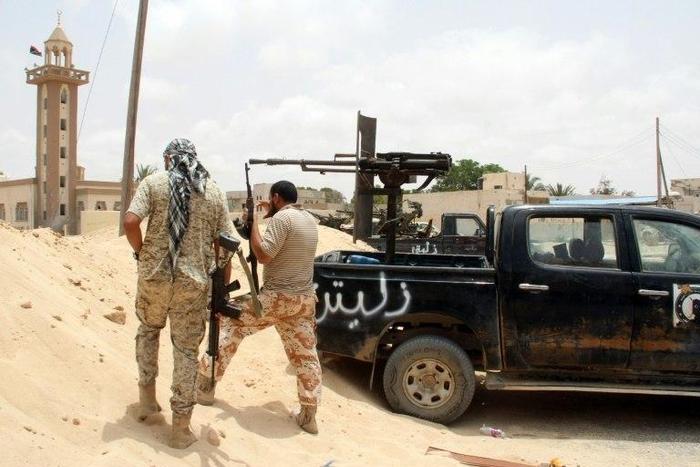 Fighters from the pro-government forces loyal to Libya's Government of National Unity (GNA) hold a position as they target the Islamic State (IS) group in Sirte on June 23, 2016
