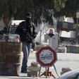 A Tunisian police officer stands guard near a police station after Monday's attack by Islamist fighters on an army and police barracks in the town of Ben Guerdan, Tunisia, near the Libyan border March 8, 2016. REUTERS/Zoubeir Souissi