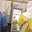 Health workers put on protective gear before entering a quarantine zone at a Red Cross facility in the town of Koidu, Kono district in Eastern Sierra Leone December 19, 2014. REUTERS/Baz Ratner