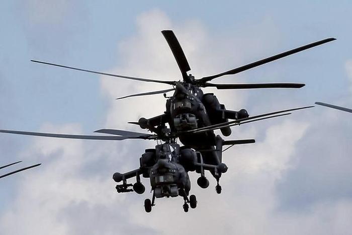 Russian Mi-28Ns from the Berkuty (Golden Eagles) helicopter display team fly in formation during the Aviadarts military aviation competition at the Dubrovichi range near Ryazan, Russia, August 2, 2015. REUTERS/Maxim Shemetov