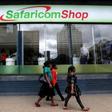 Pedestrians walk past a mobile phone care centre operated by Kenyan's telecom operator Safaricom in the central business district of Kenya's capital Nairobi, May 11, 2016.