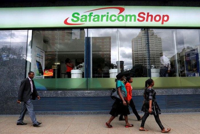 Pedestrians walk past a mobile phone care centre operated by Kenyan's telecom operator Safaricom in the central business district of Kenya's capital Nairobi, May 11, 2016.