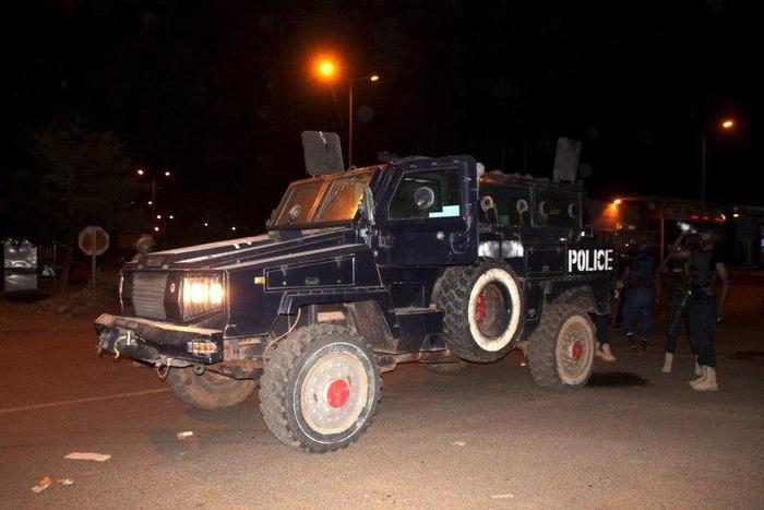 Malian police stand guard in an armored vehicle near the site of an attack on a hotel in Bamako that had been converted into the headquarters of a European Union military training operation, March 21, 2016. REUTERS/Adama Diarra