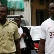 Tobechukwu Igbokwe with a prison guard