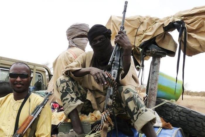 Militiaman from the Ansar Dine Islamic group sit on a vehicle in Gao in northeastern Mali, June 18, 2012.
