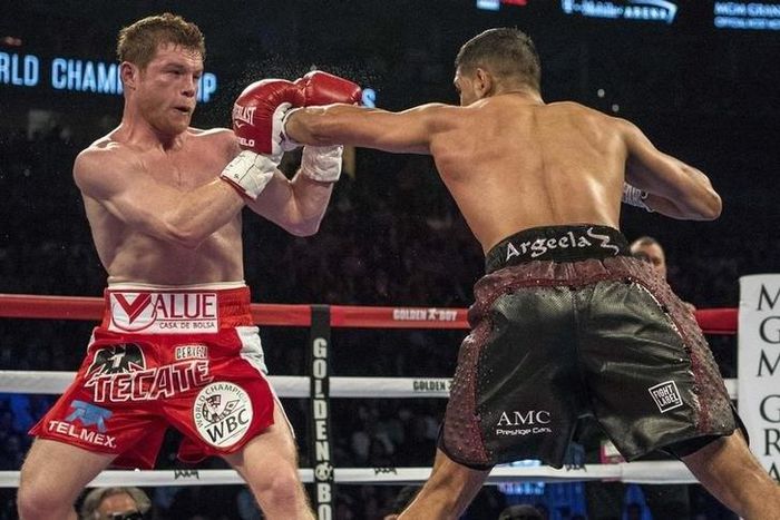 Amir Khan (maroon shorts) punches Canelo Alvarez (red shorts) during their middleweight boxing title fight at T-Mobile Arena.