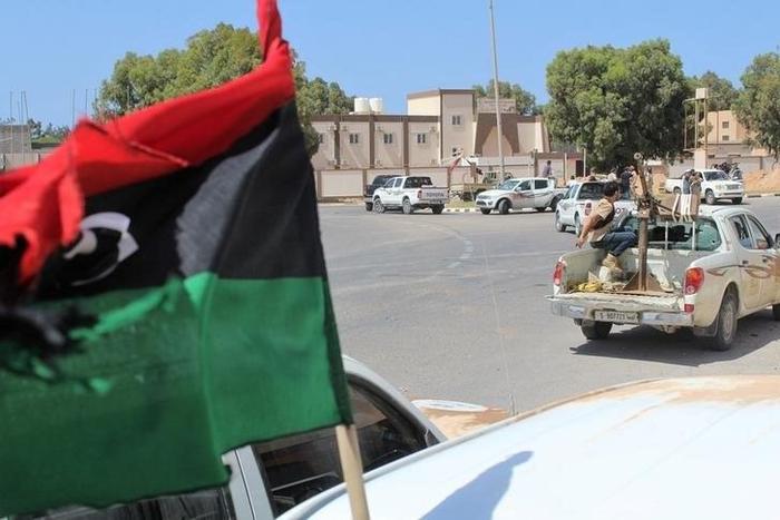 Forces aligned with Libya's new unity government advance along a road in Sirte, June 10, 2016.