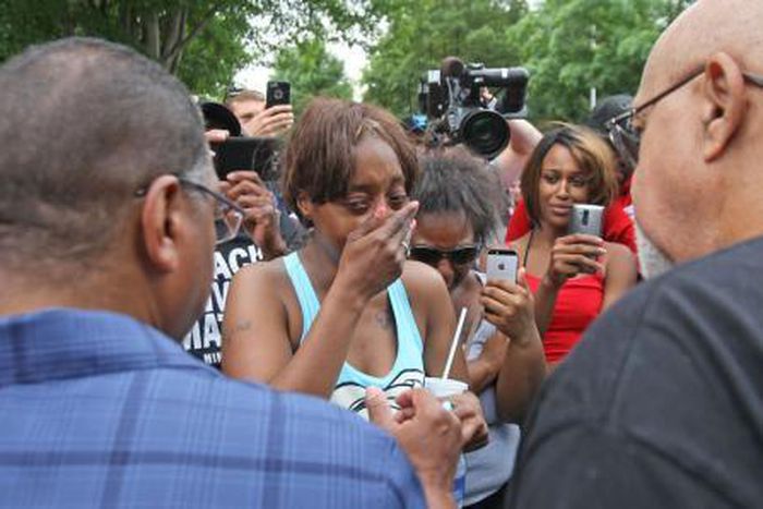 Diamond Reynolds weeps after she recounts the incidents that led to the fatal shooting of her boyfriend Philando Castile by Minneapolis area police during a traffic stop on Wednesday, at a "Black Lives Matter" demonstration, in front of the Governor"s ...
