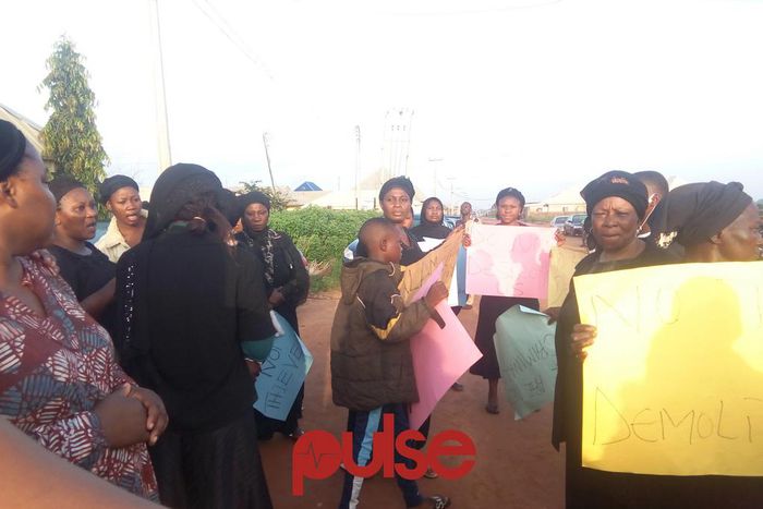 Women, children protest government's plan to demolish homes