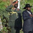 South Sudan's President Salva Kiir (R) and his First Vice President Riek Machar (L) stand during the national anthem after he was sworn-in at the Presidential House in South Sudan's capital Juba, April 26, 2016.