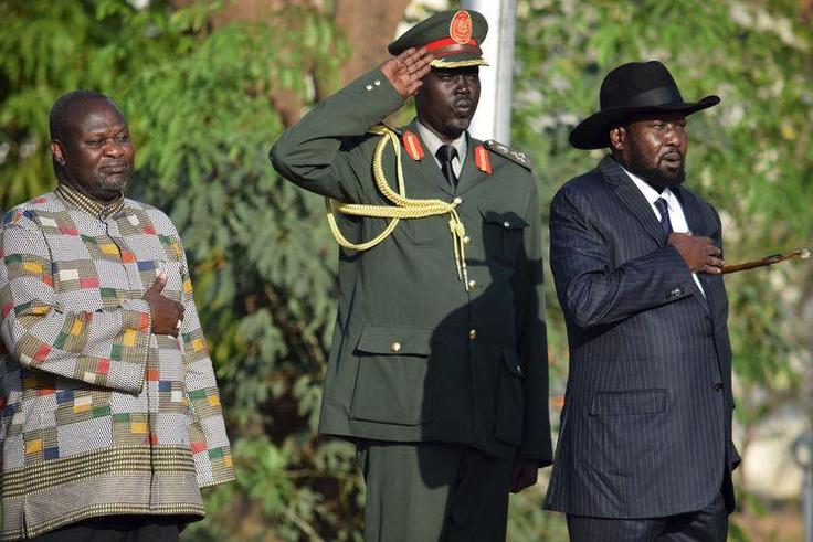 South Sudan's President Salva Kiir (R) and his First Vice President Riek Machar (L) stand during the national anthem after he was sworn-in at the Presidential House in South Sudan's capital Juba, April 26, 2016.