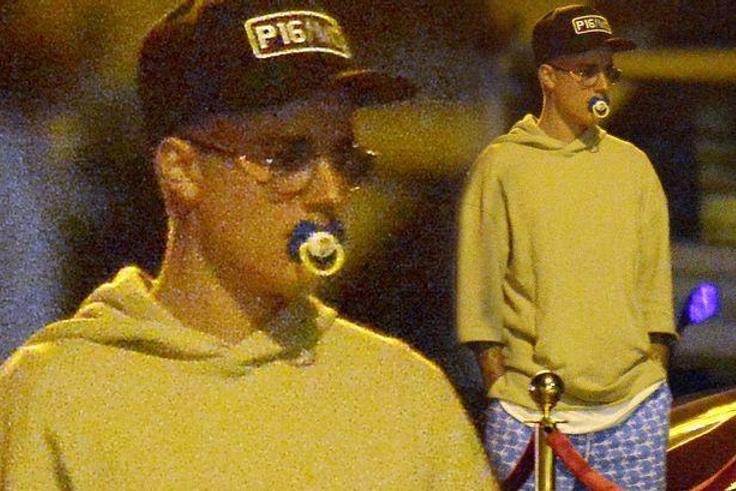 Justin Bieber sucking on a pacifier