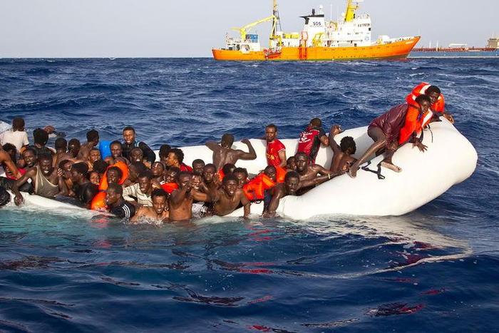 Migrants sit in a rubber dinghy during a rescue operation by SOS Mediterranee ship Aquarius off the coast of the Italian island of Lampedusa in this handout received April 18, 2016.