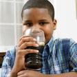 Young boy drinking soda