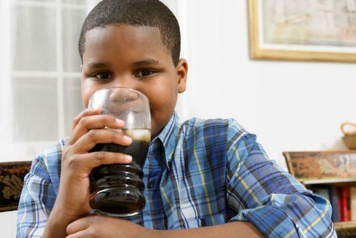 Young boy drinking soda