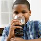 Young boy drinking soda