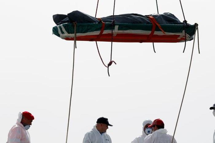 A dead body is disembarked from the Italian Navy vessel Vega at the Reggio Calabria harbour, southern Italy, May 29, 2016.
