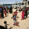 Iraqi civilians gather at a camp for displaced people after fleeing towns south of Mosul during fighting between Iraqi security forces and the Islamic State (IS) group 