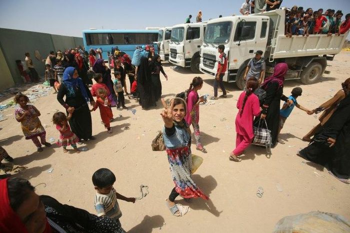 Iraqi civilians gather at a camp for displaced people after fleeing towns south of Mosul during fighting between Iraqi security forces and the Islamic State (IS) group 