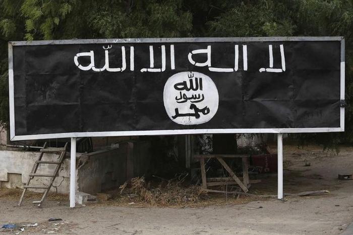 A signpost painted by Boko Haram is seen in the recently retaken town of Damasak, Nigeria, March 18, 2015.  REUTERS/Emmanuel Braun
