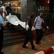 Malian officials carry a corpse outside the Radisson hotel in Bamako, Mali, November 20, 2015. REUTERS/Joe Penney