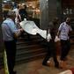 Malian officials carry a corpse outside the Radisson hotel in Bamako, Mali, November 20, 2015. REUTERS/Joe Penney