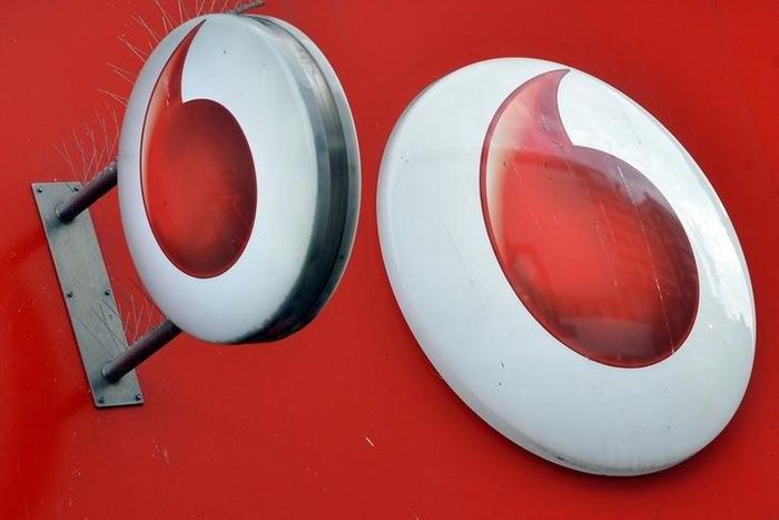 Vodafone branding is seen outside a retail store in London, file.
