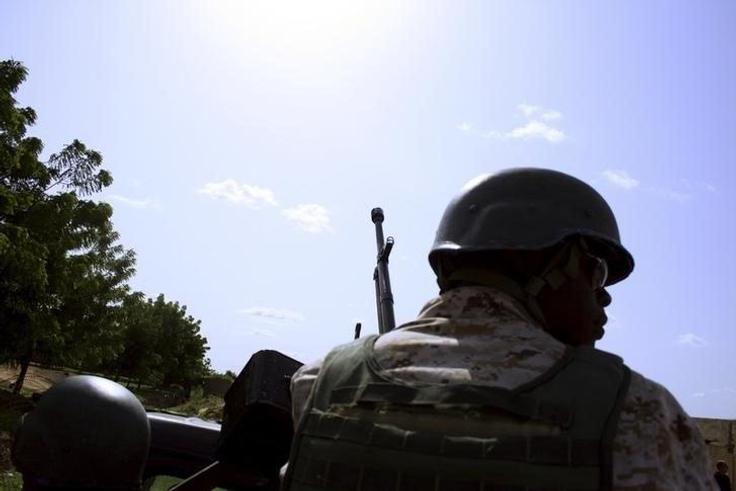 A soldier from Niger escorts U.S. soldiers back to their base following an anti-Boko Haram summit in Diffa city, Niger September 3, 2015.