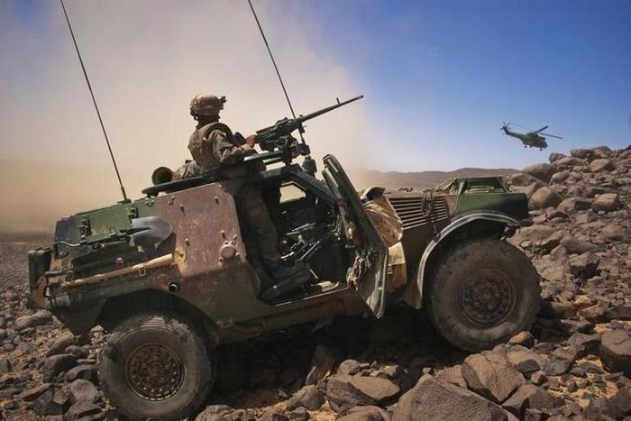 A French soldier stands guard in an armoured vehicle , about 60 km (37 miles) south of the town of Tessalit in northern Mali March 21, 2013.
