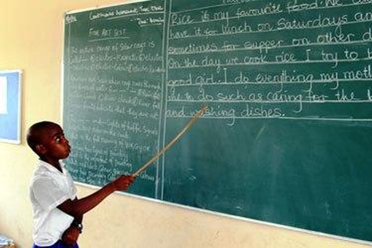 A pupil reading from the chalkboard
