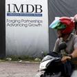 Motorcyclists pass a 1Malaysia Development Berhad (1MDB) billboard at the Tun Razak Exchange development in Kuala Lumpur, Malaysia, February 3, 2016. REUTERS/Olivia Harris/File Photo