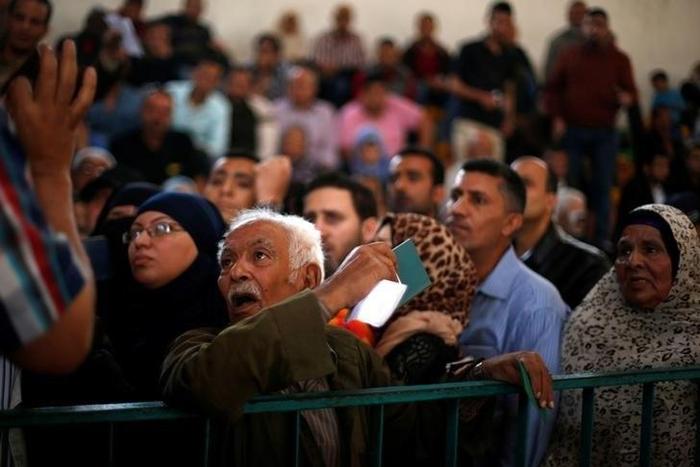 A man asks for a travel permit to cross into Egypt through the Rafah border crossing after it was opened for two days by Egyptian authorities, in the southern Gaza Strip May 11, 2016.