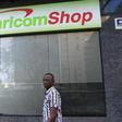 A man walks past a Safaricom shop, a mobile telecommunication provider in Kenya's capital Nairobi November 15, 2015.