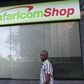A man walks past a Safaricom shop, a mobile telecommunication provider in Kenya's capital Nairobi November 15, 2015.