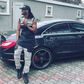 Paul Okoye leaning on his Mercedes Benz.