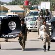 Shi'ite paramilitary fighters hold an Islamist State flag which they pulled down during victory celebrations after returning from Tikrit in Kerbala, southwest of Baghdad April 4, 2015.    REUTERS/Mushtaq Muhammed