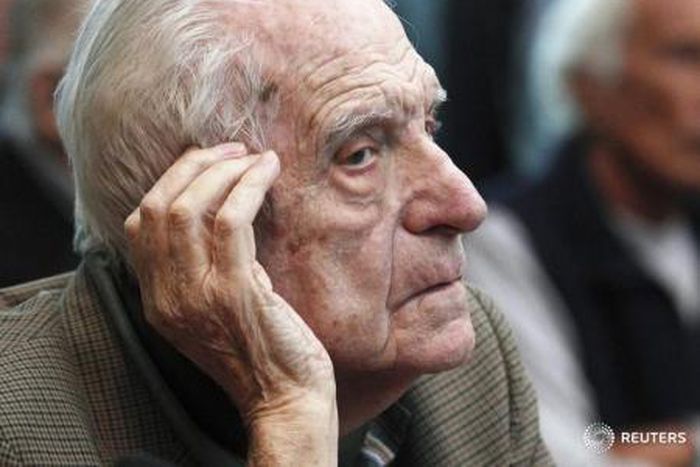 Argentina's former President and Army Chief Reynaldo Bignone sits in a courthouse during the first day of his trial, accused of participating in "Operation Condor", in Buenos Aires March 5, 2013.