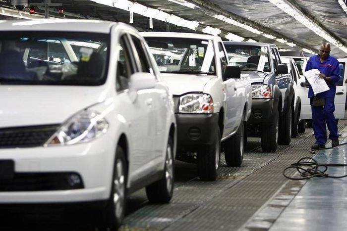 A worker inspects cars at Nissan's manufacturing plant in Rosslyn, outside Pretoria, in a file photo.