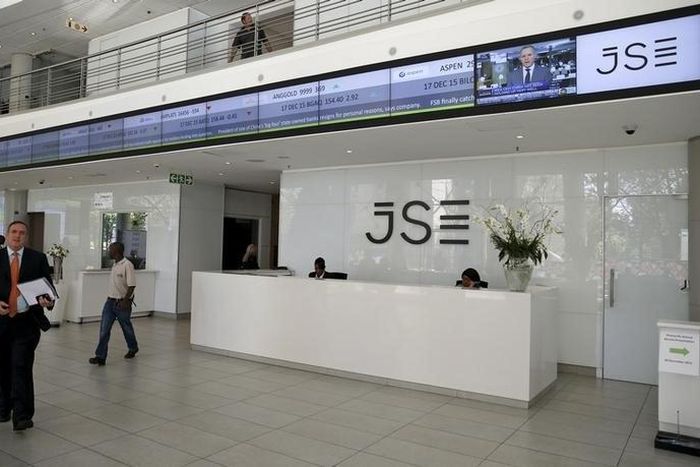 People walk near the reception at the Johannesburg Stock Exchange (JSE) in Sandton, Johannesburg, South Africa December 10, 2015.