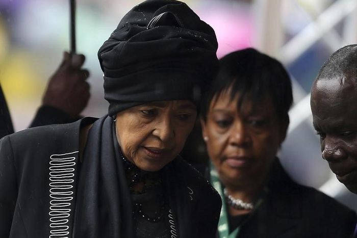 Former South African President Nelson Mandela's ex-wife Winnie Mandela (L) arrives at the First National Bank (FNB) Stadium, also known as Soccer City, ahead of the national memorial service for Nelson Mandela in Johannesburg December 10, 2013.