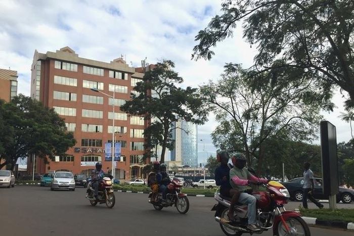 Commuters use motorcycle taxis to make their way through early morning traffic in the Rwanda's capital Kigali, May 11, 2016.