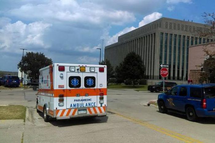 An ambulance is seen outside the Berrien County Courthouse in St. Joseph, Michigan, U.S., where a gunman opened fire killing two bailiffs and injuring a civilian and a sheriff's deputy before being shot dead, July 11, 2016.